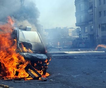 A car on fire from a terrorist attack