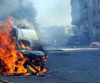 A car on fire from a terrorist attack