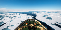 Image of the bow of a ship going through thin ice in the sea