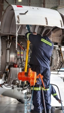 Man fixing an airplane engine