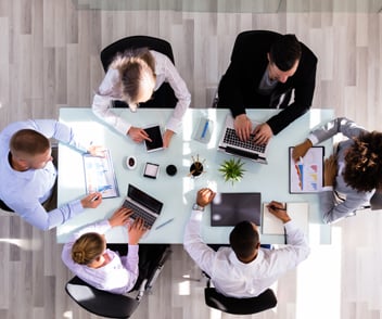 Ariel views of colleagues at a meeting table 