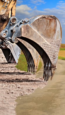 Image of a excavator in a farmland 