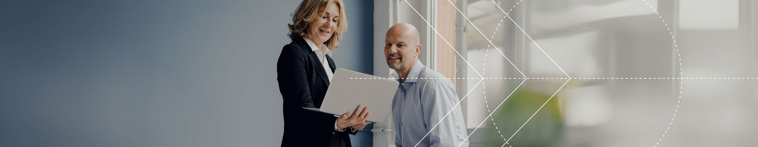  Businesswoman showing businessman something on laptop, bright atmosphere