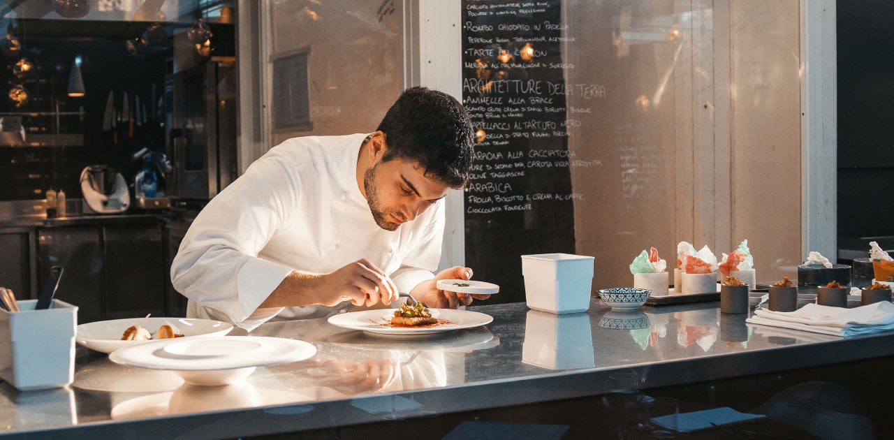  A fine dining chef is passionate about preparing a plate with attention to detail.