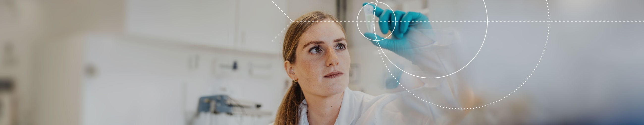Young woman in the laboratory examining a test vessel